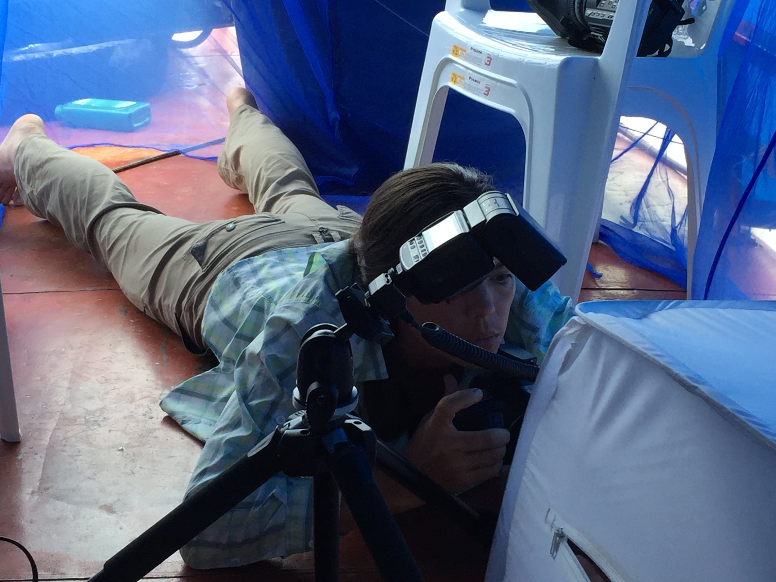  Christina Selby, Houseboat Amazon's embedded journalist, shoots into a soft lightbox on the upper deck of the barco (in the Research Palace!). Small rainforest creatures like frogs were captured, photographed, and released back where they were colle