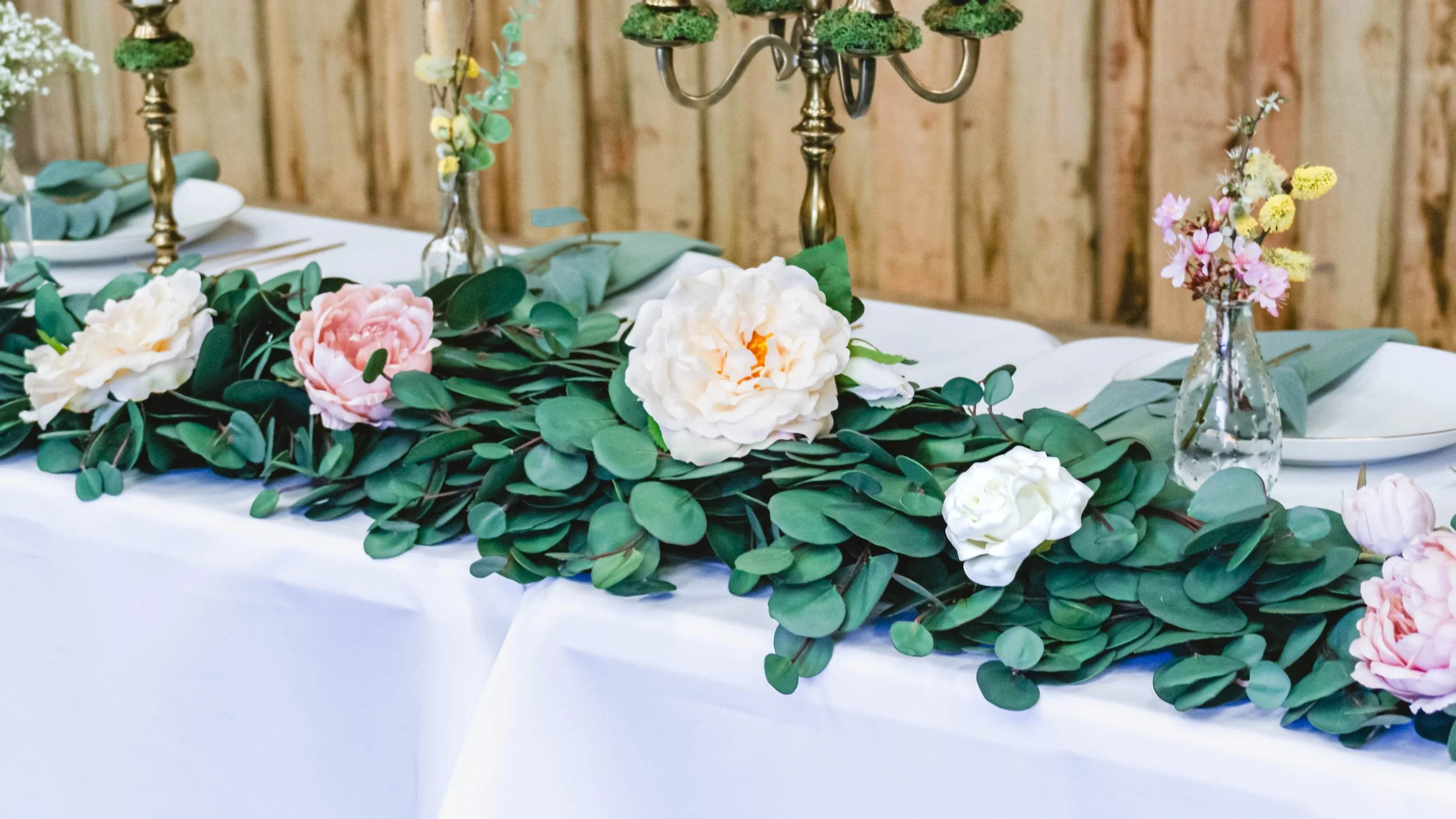 Abigail Ahern Vanilla rose displayed in eucalyptus garland.jpg