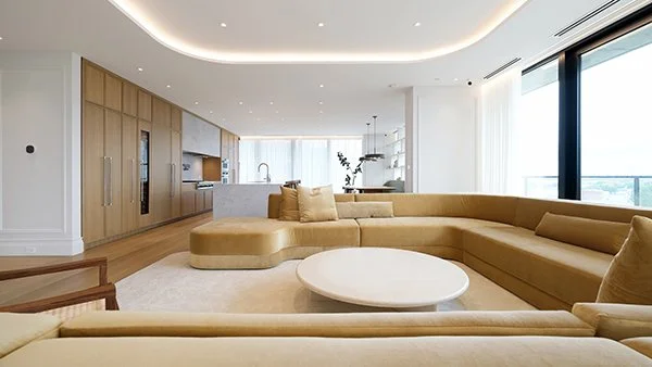 gdp2024 laureat Open-plan living room with custom curved yellow velvet sofa