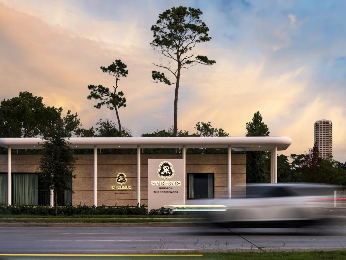 Exterior view of the St. Regis Houston residential building during sunset, with tall trees, modern architecture, and a blurred car passing by.