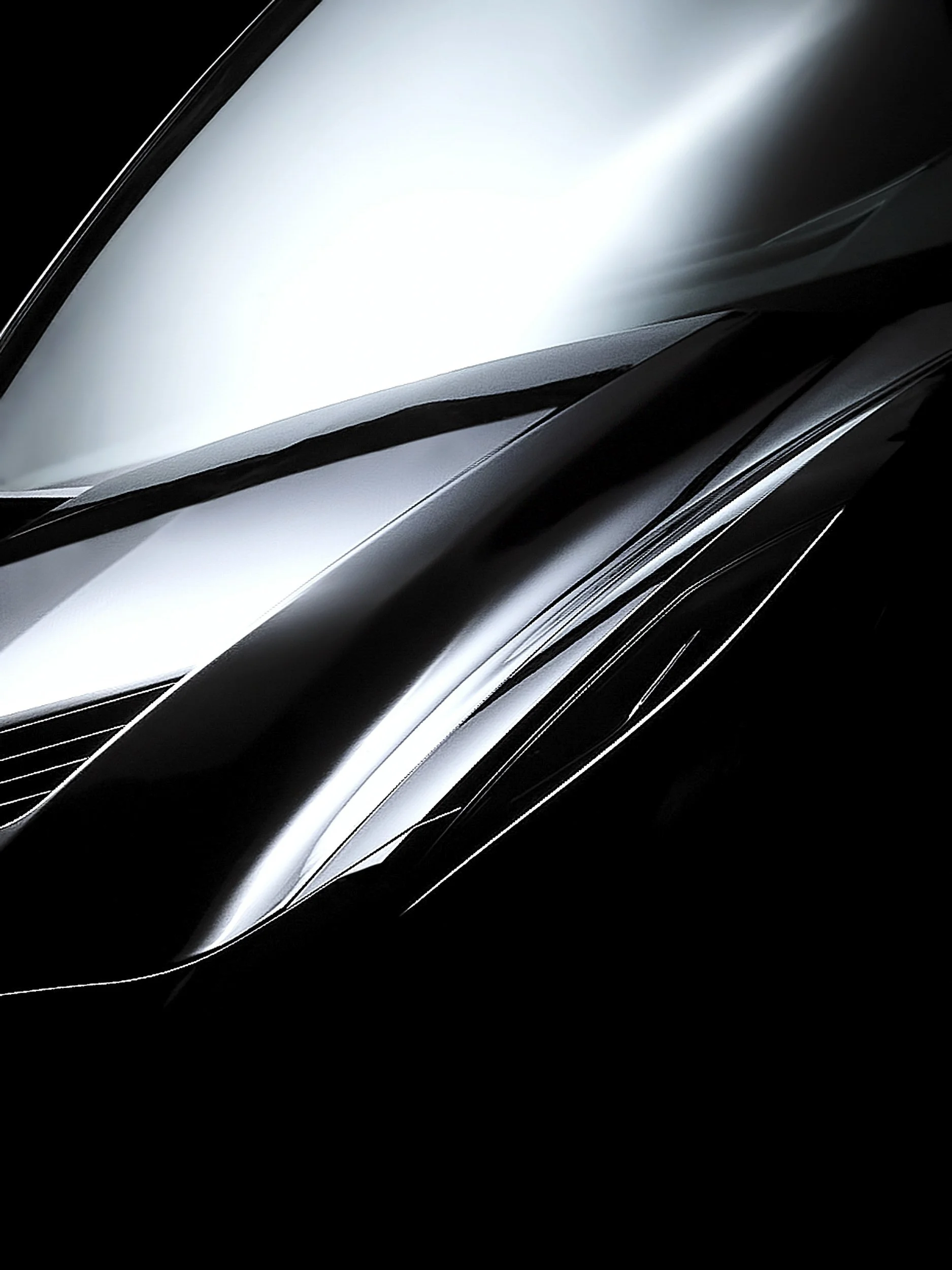 Close-up of a sleek, black and silver modern car, focusing on the front hood and part of the windshield.