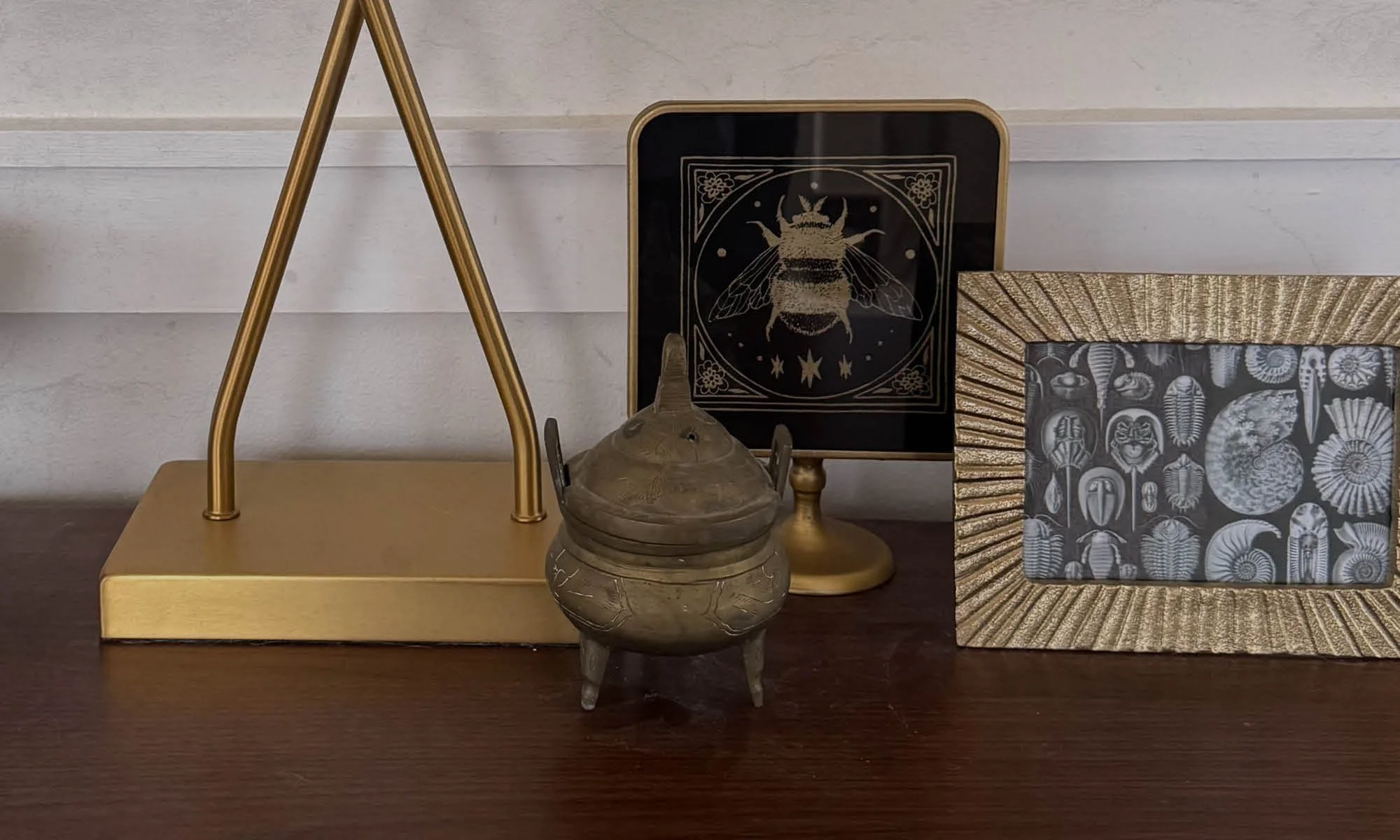 quiet interior at Longview Cottage with brass lamp and framed insect art