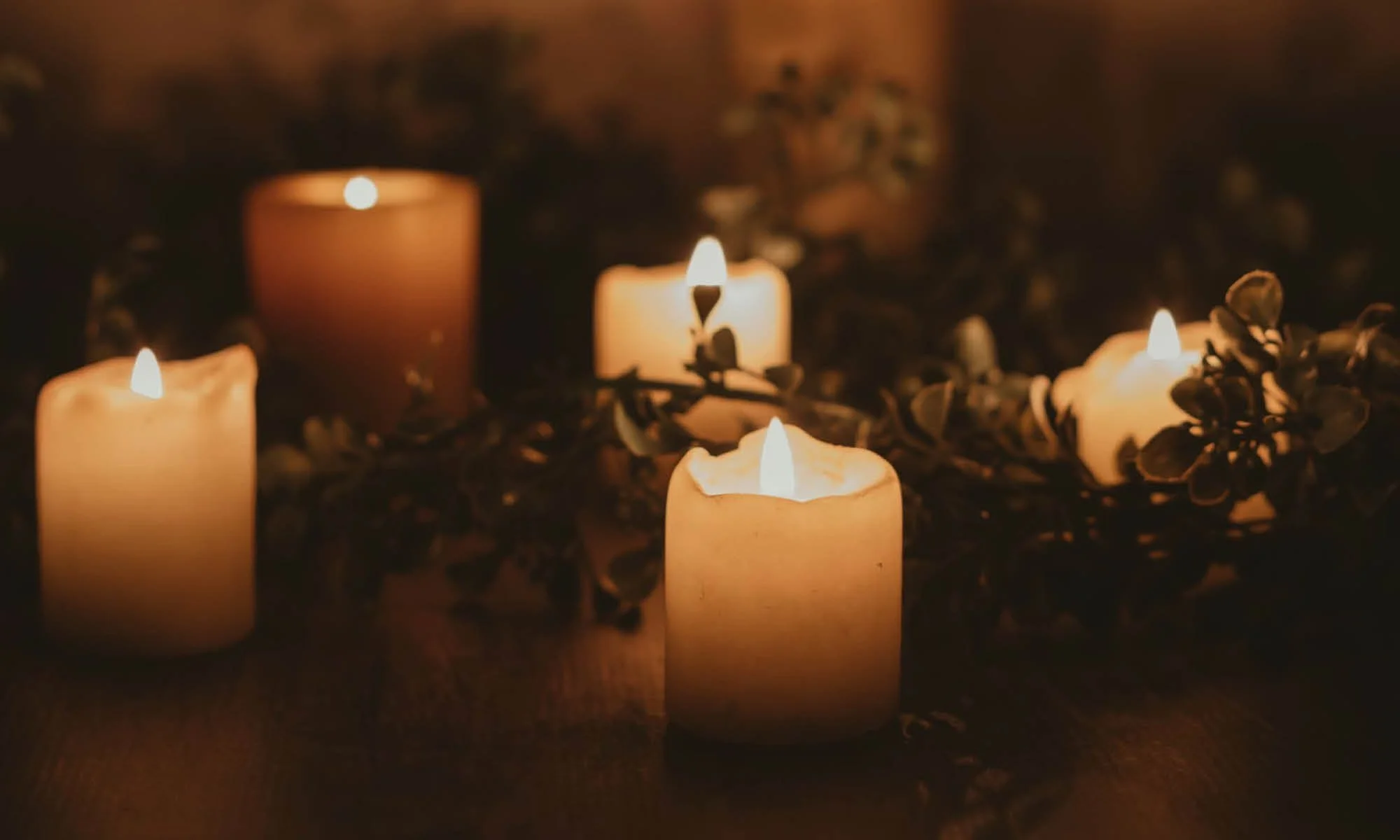 pillar candles lit and glowing on winter solstice