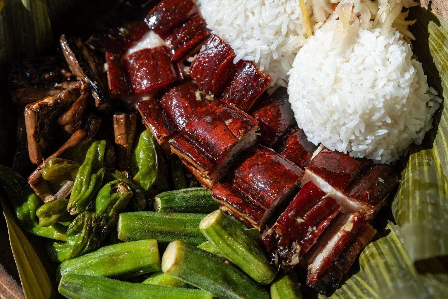 The Lechon Platter at Naks is all about the textures, the balance, the fire. You&rsquo;re getting crispy pork belly; skin shattering, fat melting, meat tender, served with fragrant jasmine rice and a lineup of grilled and pickled vegetables that brin