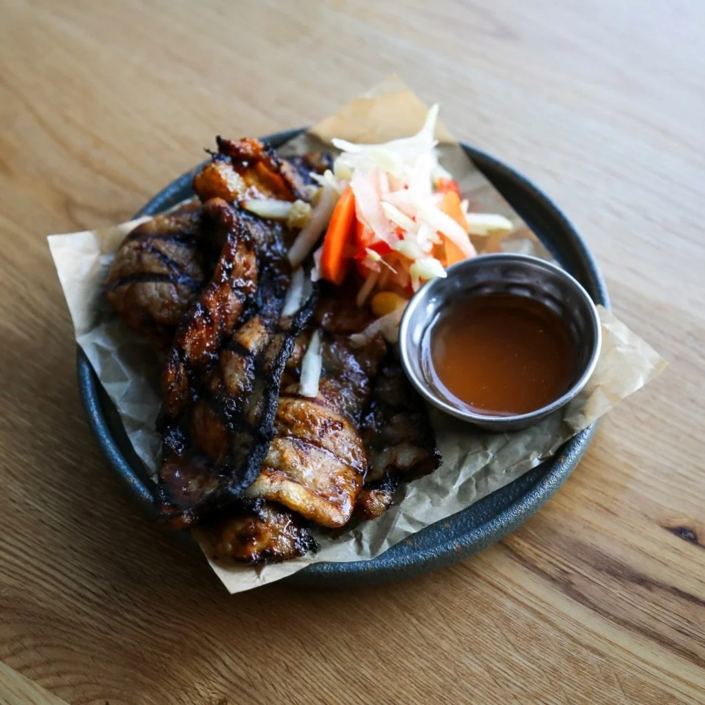Inihaw na Liempo is Filipino street grilling at its most precise.

Pork belly is marinated with a lemon soda&ndash;based glaze, a classic Filipino trick that adds sweetness, acidity, and caramelization.
Finished with banana ketchup, a wartime-born Fi