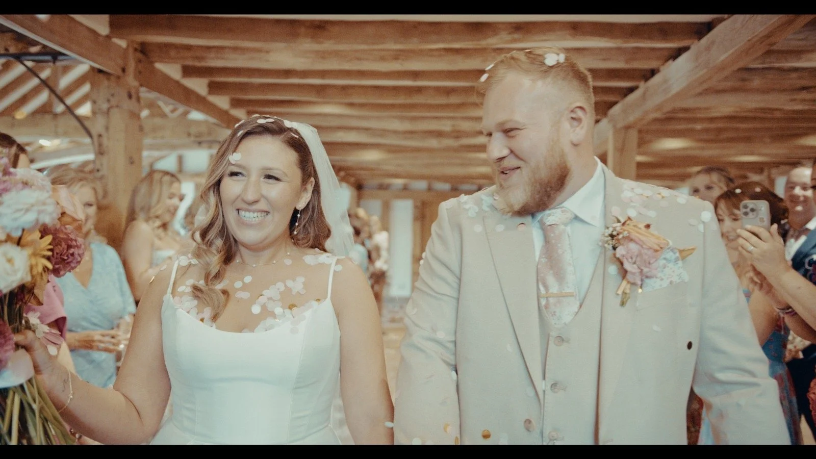 Bride and Groom smiling at each other walking down the aisle on their Wedding Day 