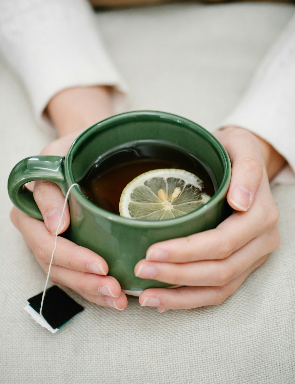 person holding cup of tea in their hands, mindfulness