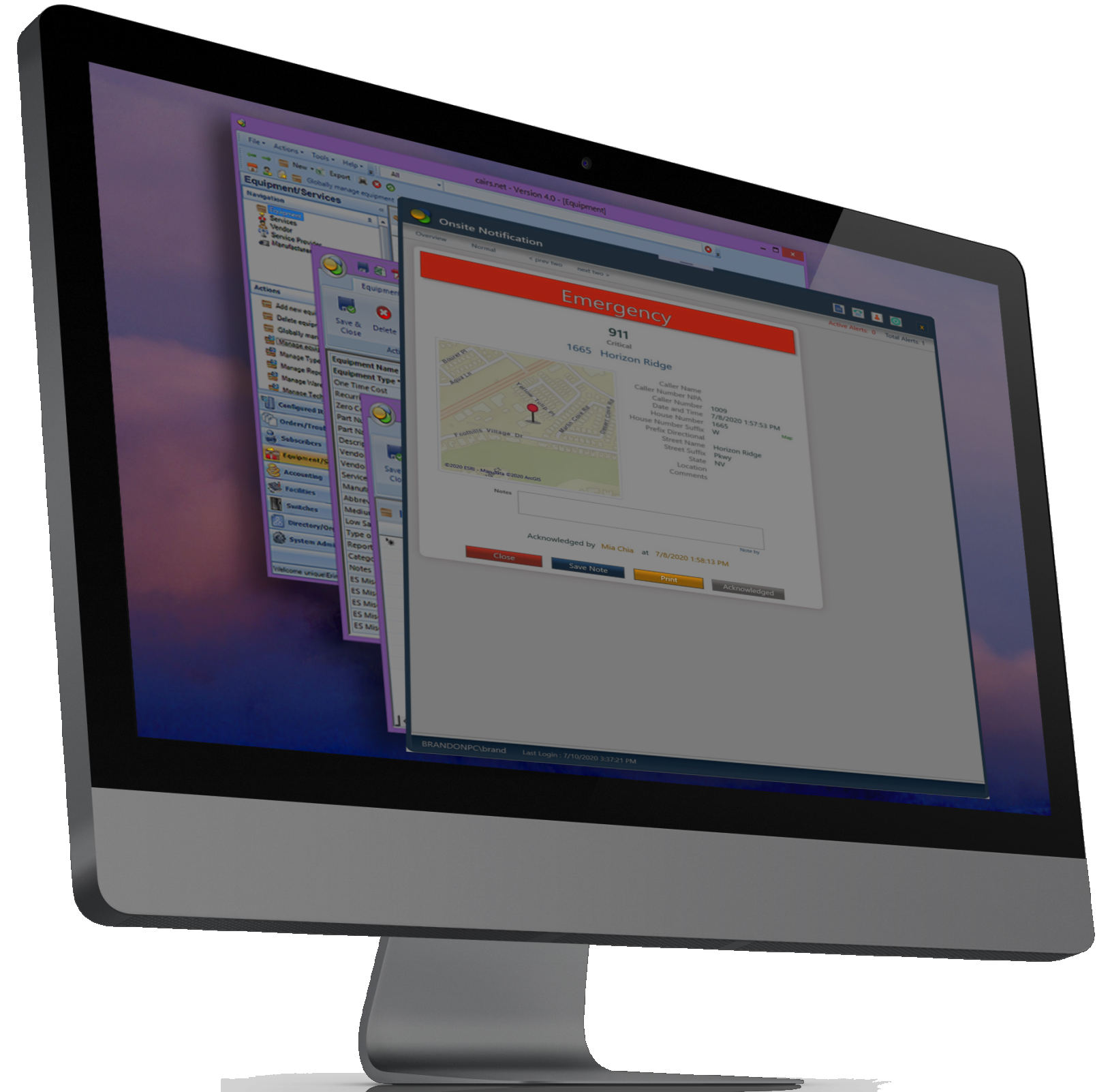 Computer monitor displaying multiple overlapping windows related to emergency response, including a map, a notification alert, and system management pages.