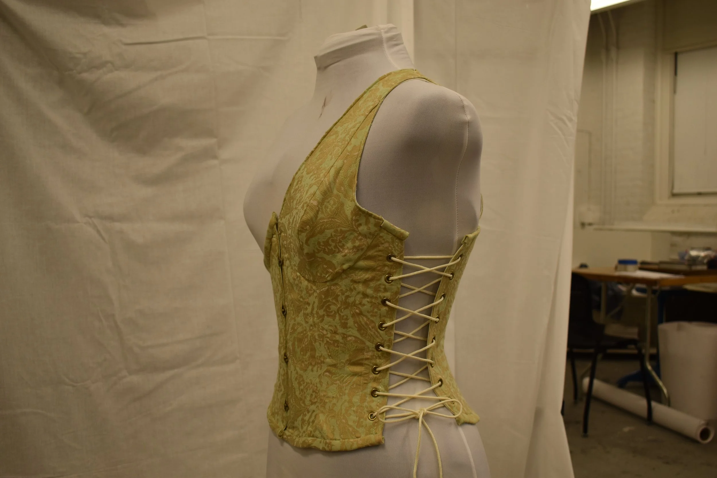 Side lacing corset. Brocade shell, coutil lining, spoon front busk.