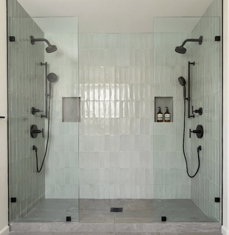 Contemporary walk-in shower with glass enclosure and matte black fixtures in East Hampton home.