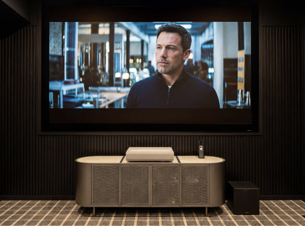 Luxury Hamptons home cinema with built-in media wall and integrated projection screen.