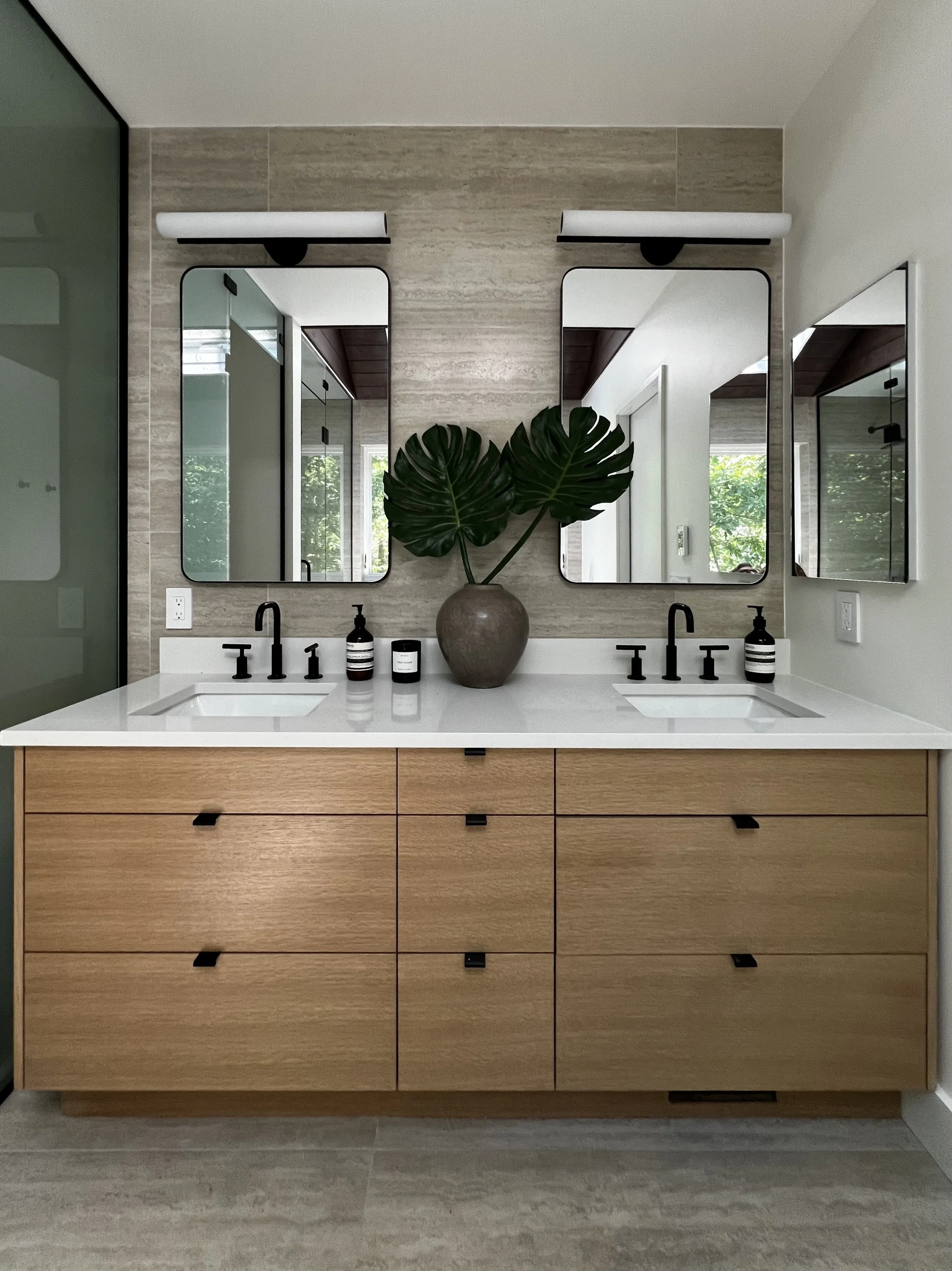 contemporary bathroom with travertine floors and white oak vanity
