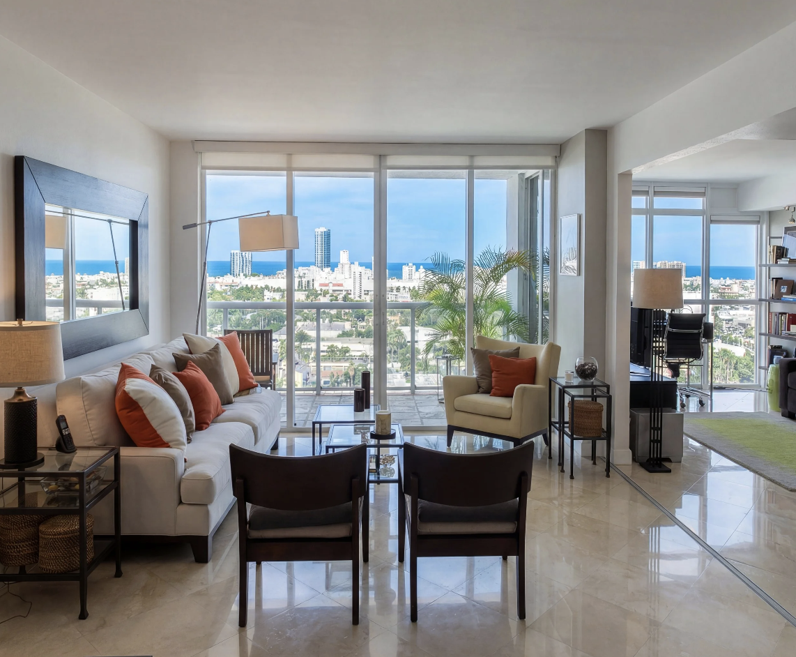 Bright oceanfront condo renovation with modern seating and floor-to-ceiling windows.