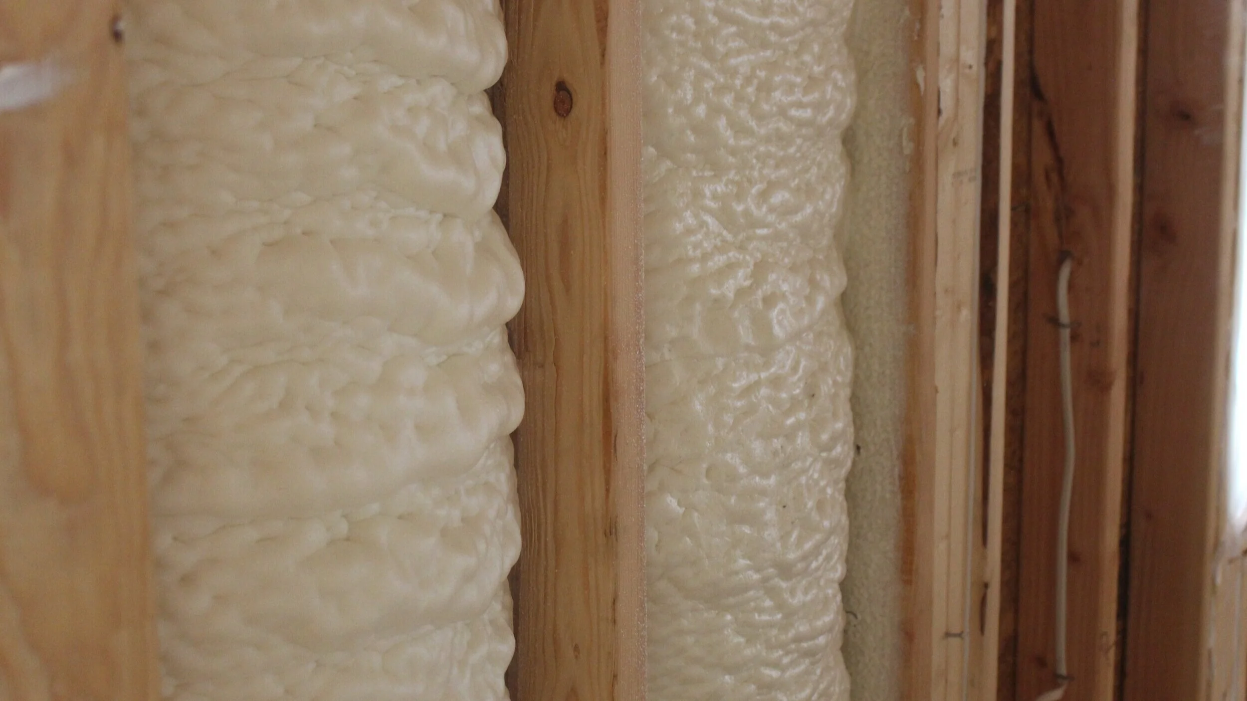 Photograph showcasing spray foam wall insulation.