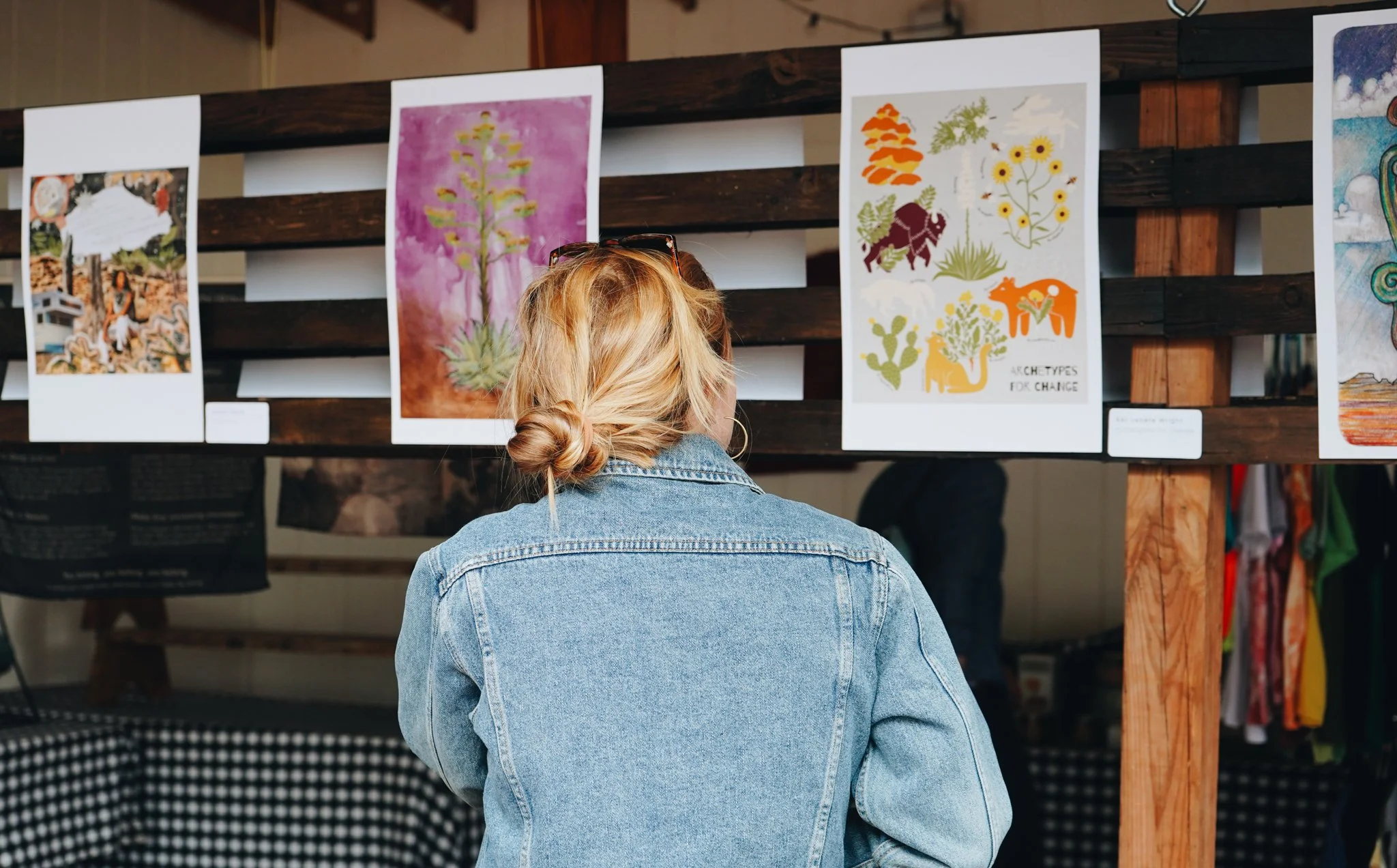 person viewing prints from visual collections within the anthology