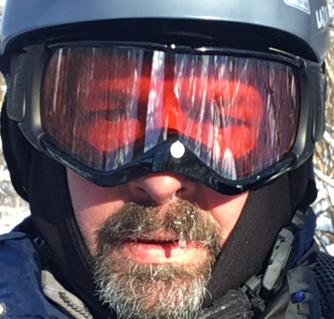 Cyclist's face with helmet, goggles and icicles on mustache