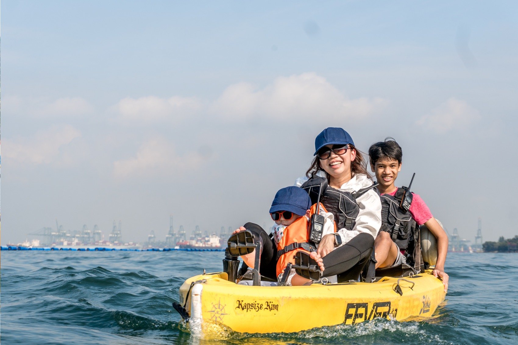 mum and 2 sons sitting on a hobie tandem compass duo kayak at sentosa Siloso beach to tanjong beach