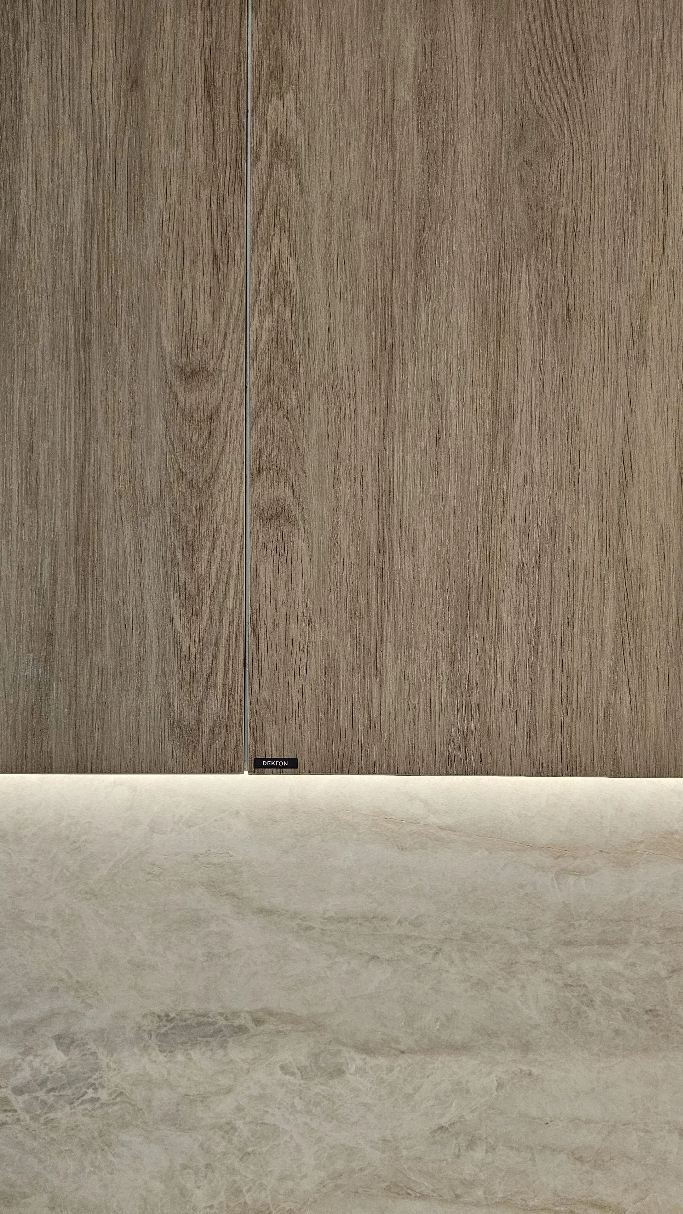 Invisible touch activation on a monolithic Dekton Kedar cabinet door wood-look surfaces.