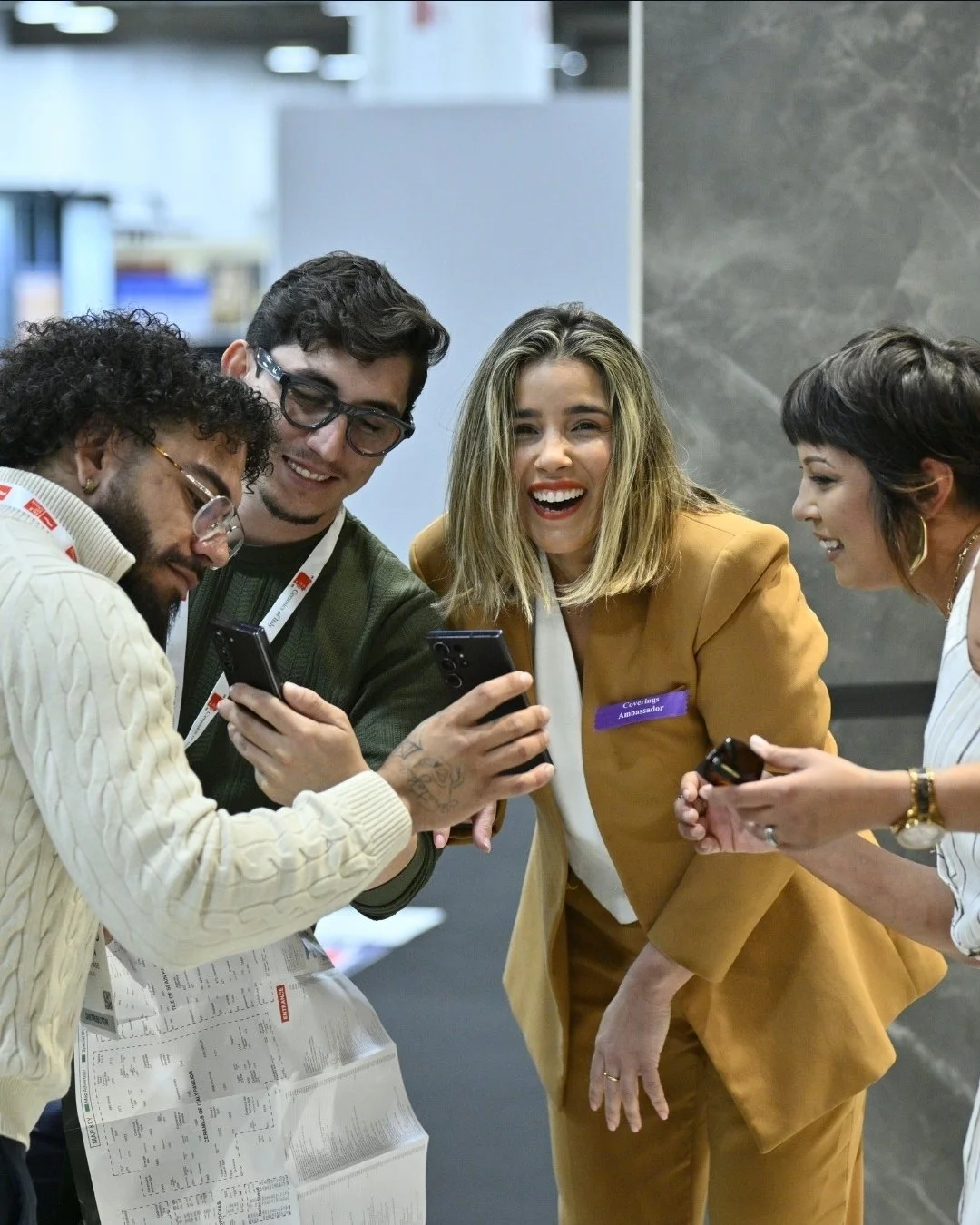 Lais Luz, Official Coverings 2026 Ambassador, sharing a moment with industry professionals at the Las Vegas Convention Center. Highlighting the networking and community aspect of the global tile and stone experience.