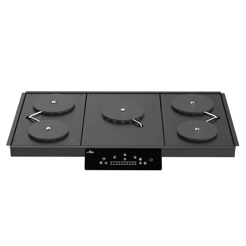 Invisacook five burner system installed under ultracompact countertop in luxury kitchen with multiple induction cooking zones
