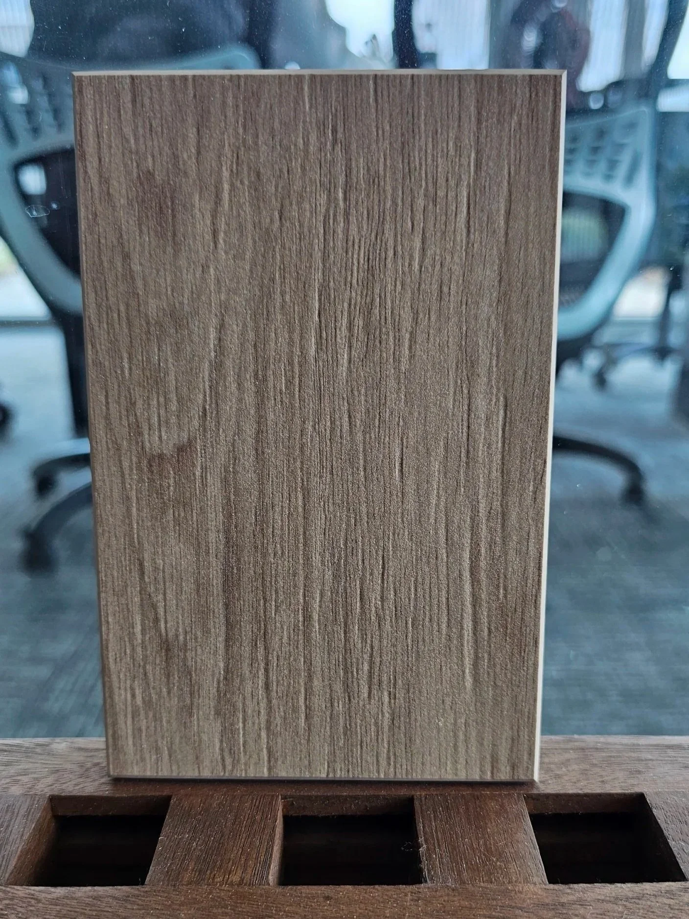 Close-up of Dekton Kedar sample showing the deep espresso grain of the matte dark wood-look finish.