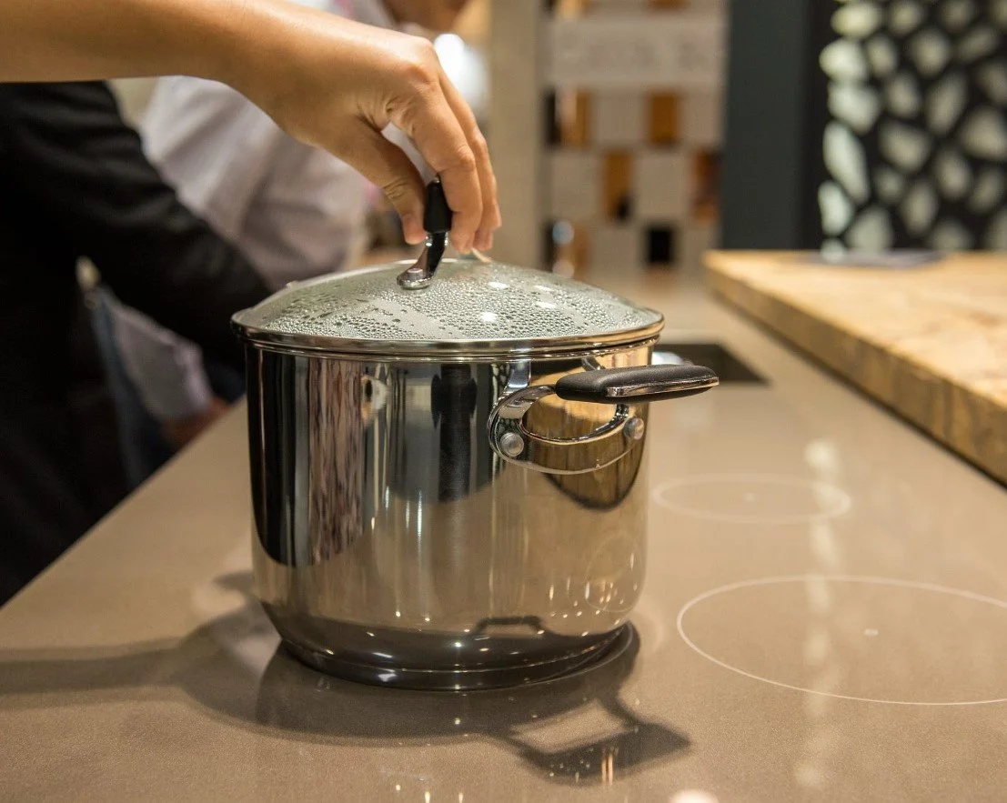 Innovative Invisacook invisible induction burner installed directly beneath a seamless, silica-free countertop for a minimalist and functional modern kitchen design.