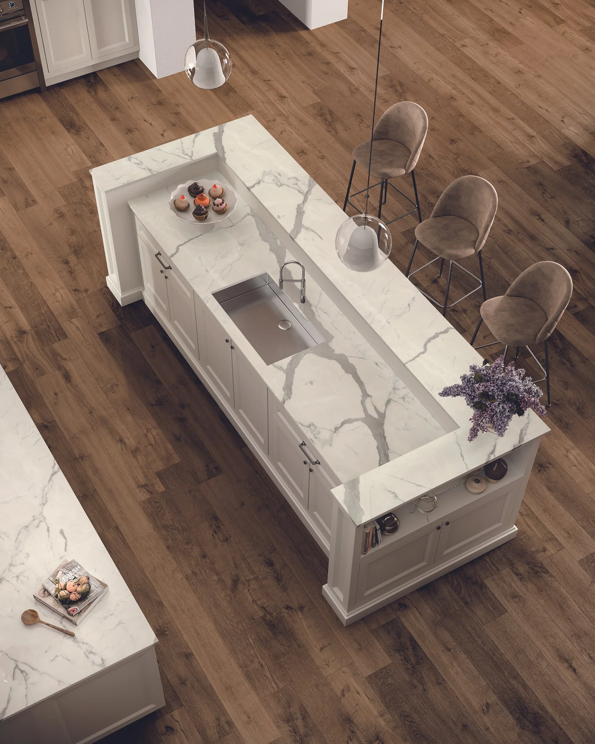 This bird's-eye view reveals the unique design of this double-level island, crafted from 2cm Statuario Supremo porcelain. The expansive surface area offers both functionality and visual interest, with a dedicated space for prepping and serving, and a