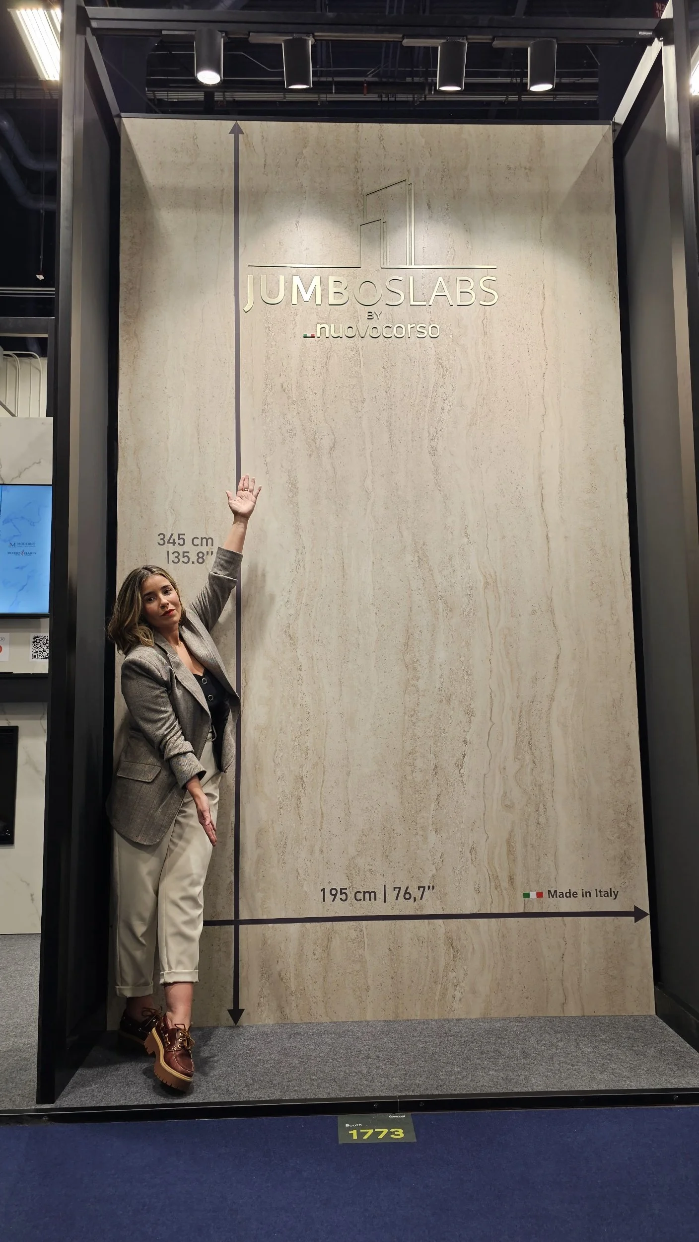 Lais Luz at the Nuovocorso booth featuring the world's largest porcelain Jumboslabs. Measuring 345cm by 195cm, these record-breaking Italian mineral surfaces are ideal for seamless, monolithic luxury kitchen and wall installations.