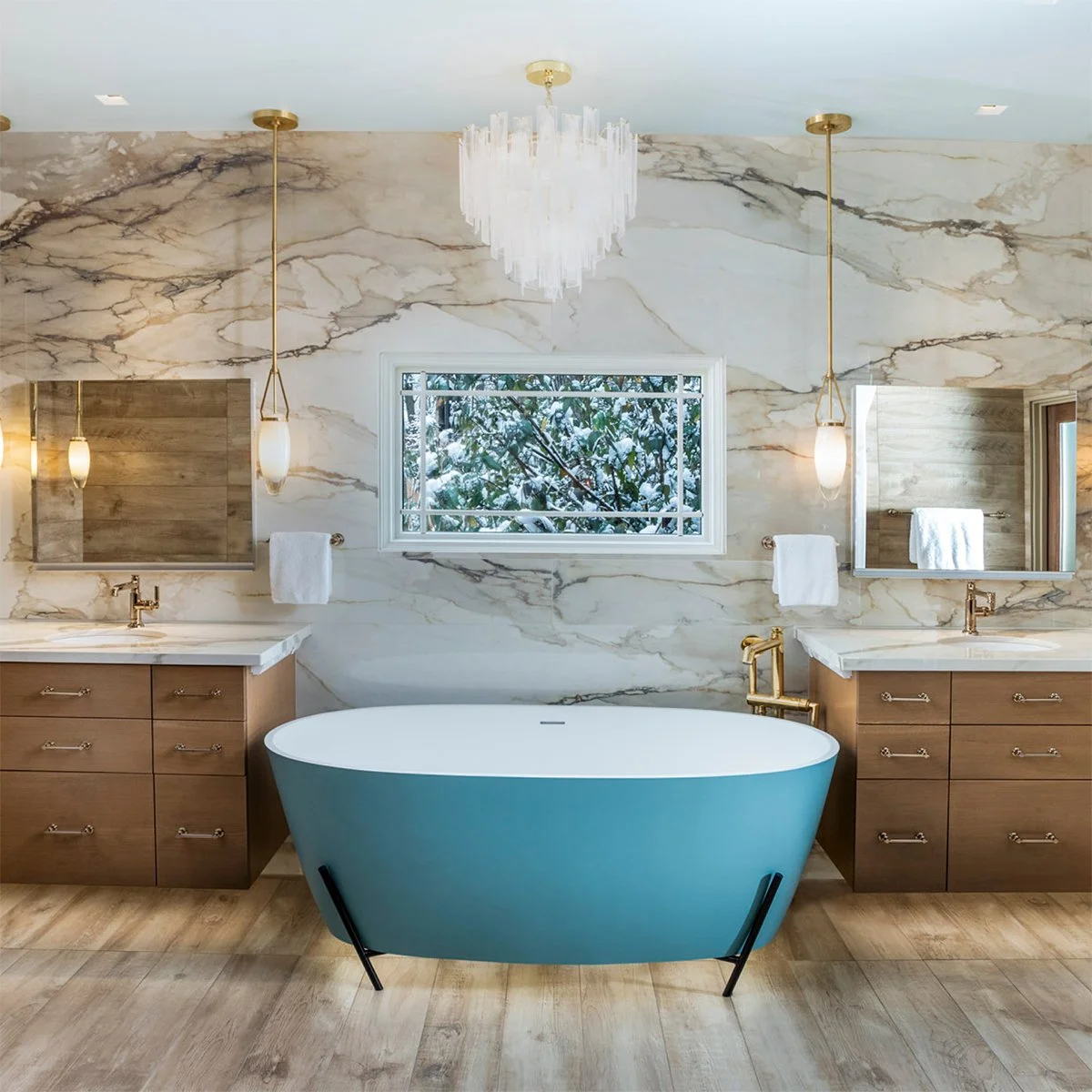 A luxury residential bathroom walk-in shower lined with seamless Atlas Plan Calacatta Antique large format porcelain slabs.