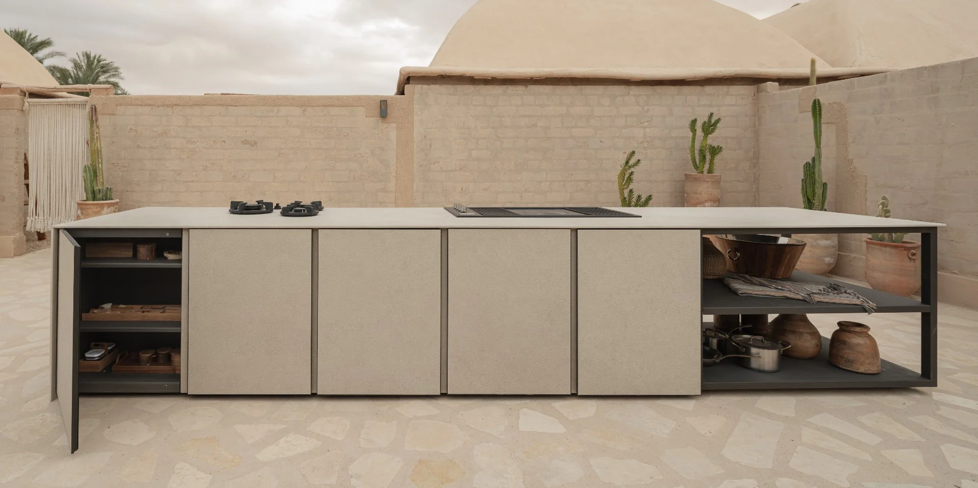 A luxury modern outdoor kitchen featuring weatherproof Capo Cuoco cabinetry designed for coastal Florida homes.