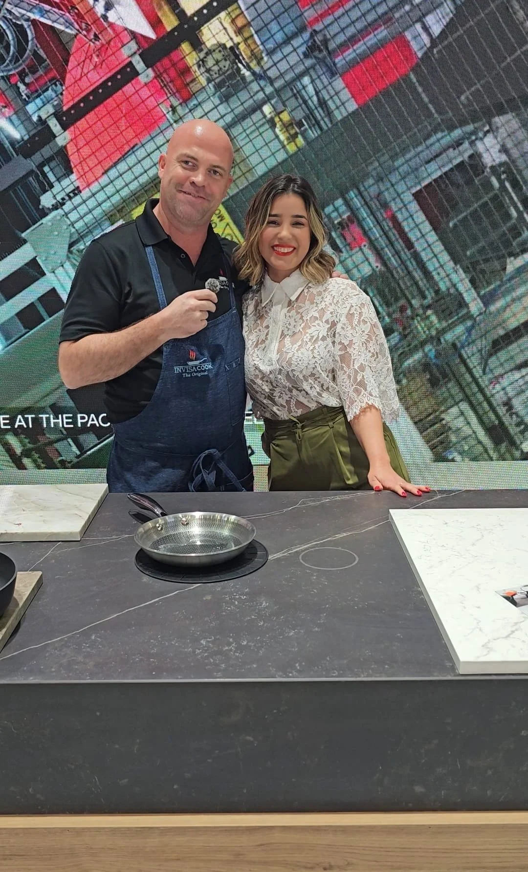 Official Ambassador Laís Luz and Invisacook CEO Hans King conducting a live invisible induction demonstration on an ultracompact surface Dekton at KBIS.