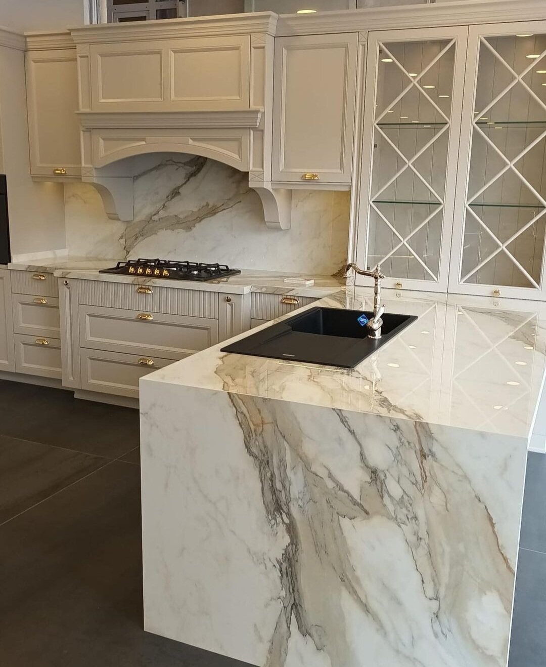 Luxury redefined. Infinity Calacatta Hermitage countertops, backsplash, and waterfall island.