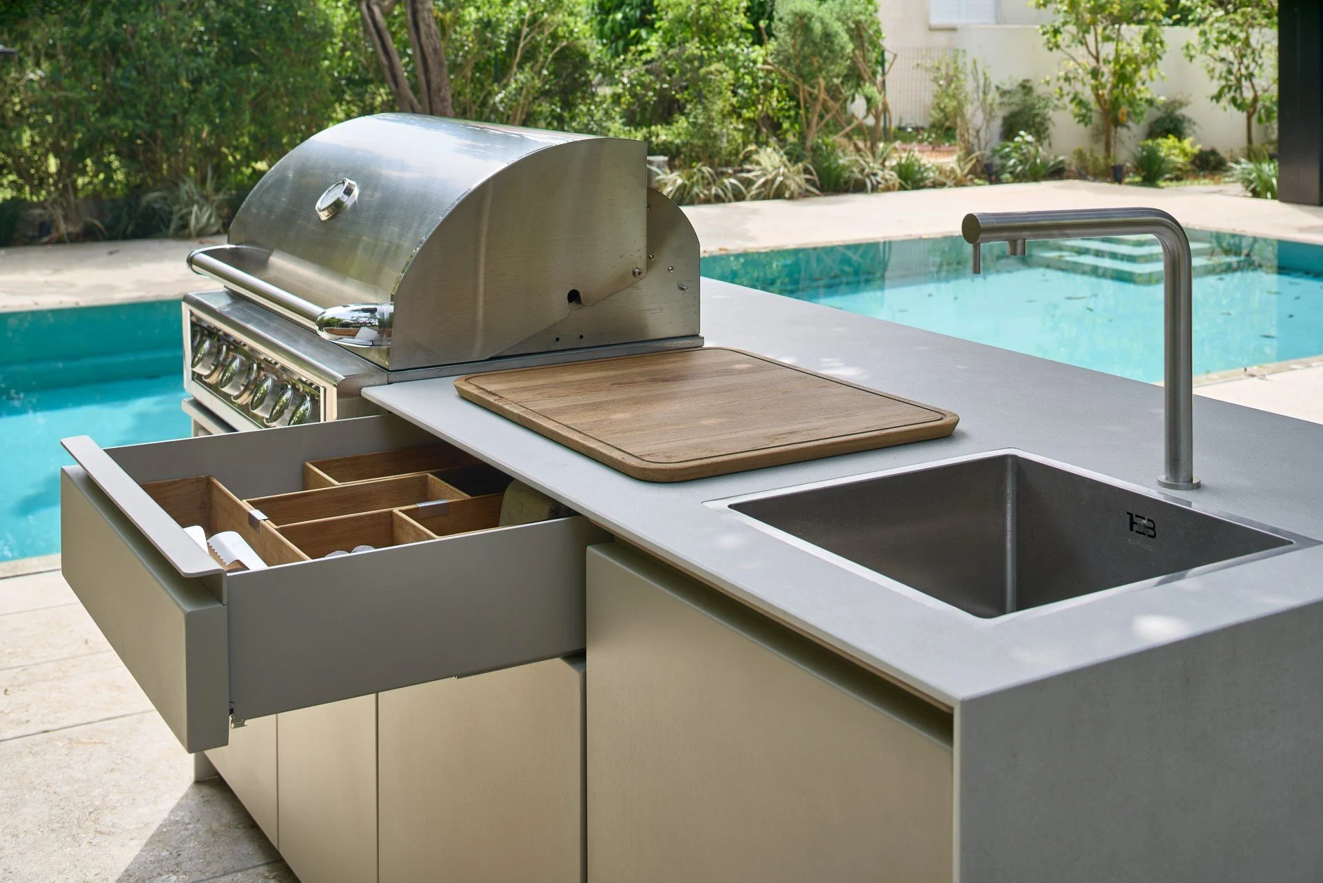 Close-up view of the marine-grade powder-coated aluminum cabinetry frame showing hidden beveled handles and soft-close cabinet drawers.