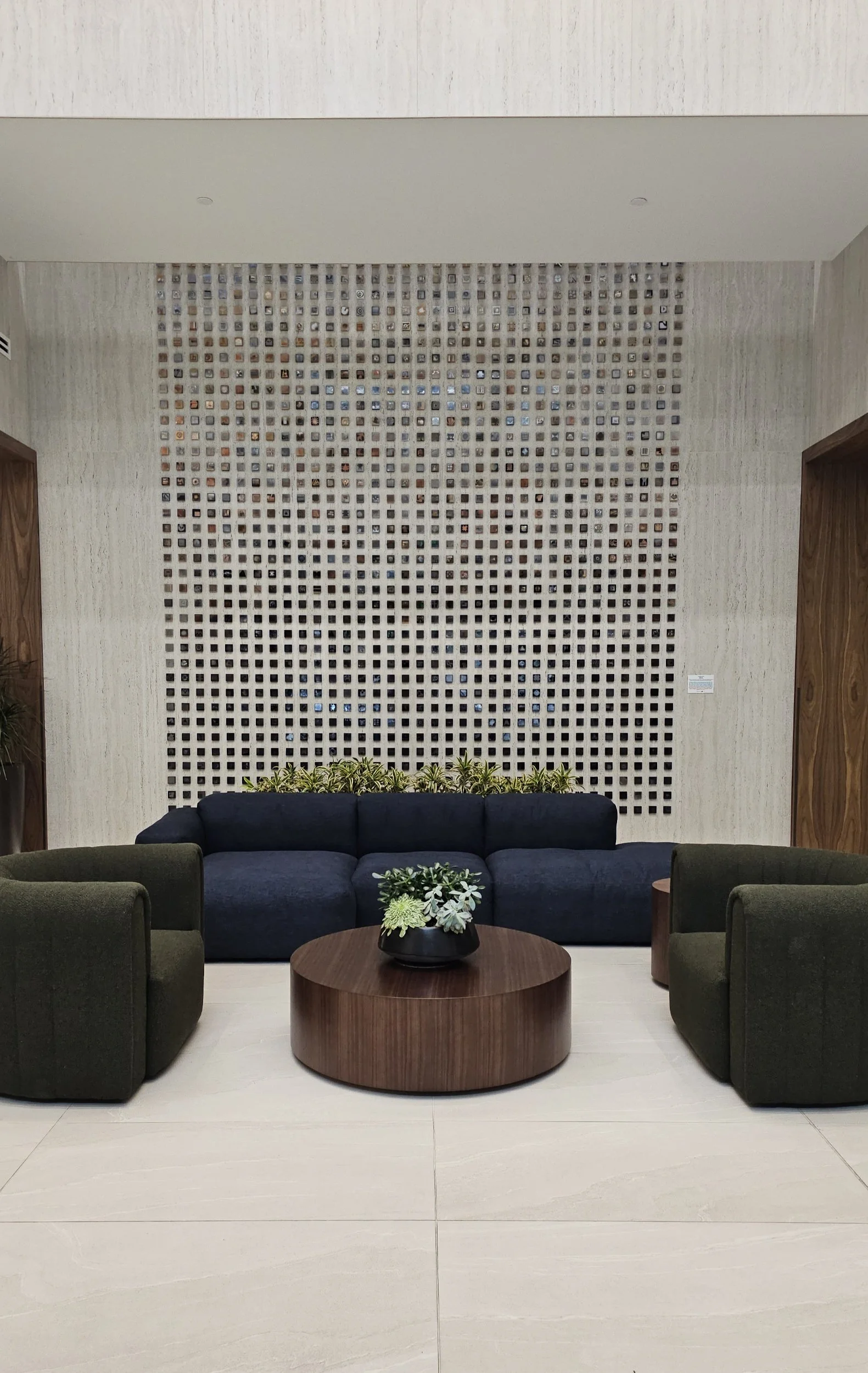 Striking entryway accent wall clad with a unique pattern and porcelain slabs.