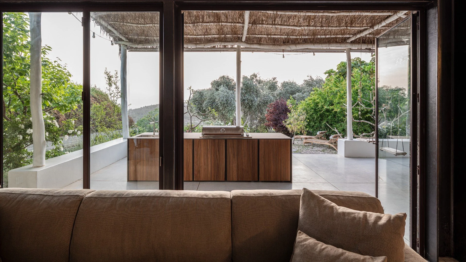 A luxury modular outdoor kitchen setup featuring Capo Cuoco luxury outdoor cabinetry and matching high-performance stone surfaces.