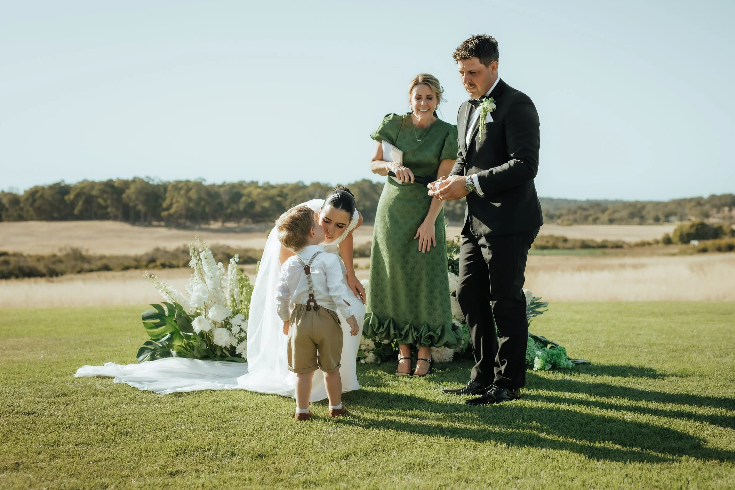 Nephew kisses bride during ceremony at tiller farm in the south west Western Australia 