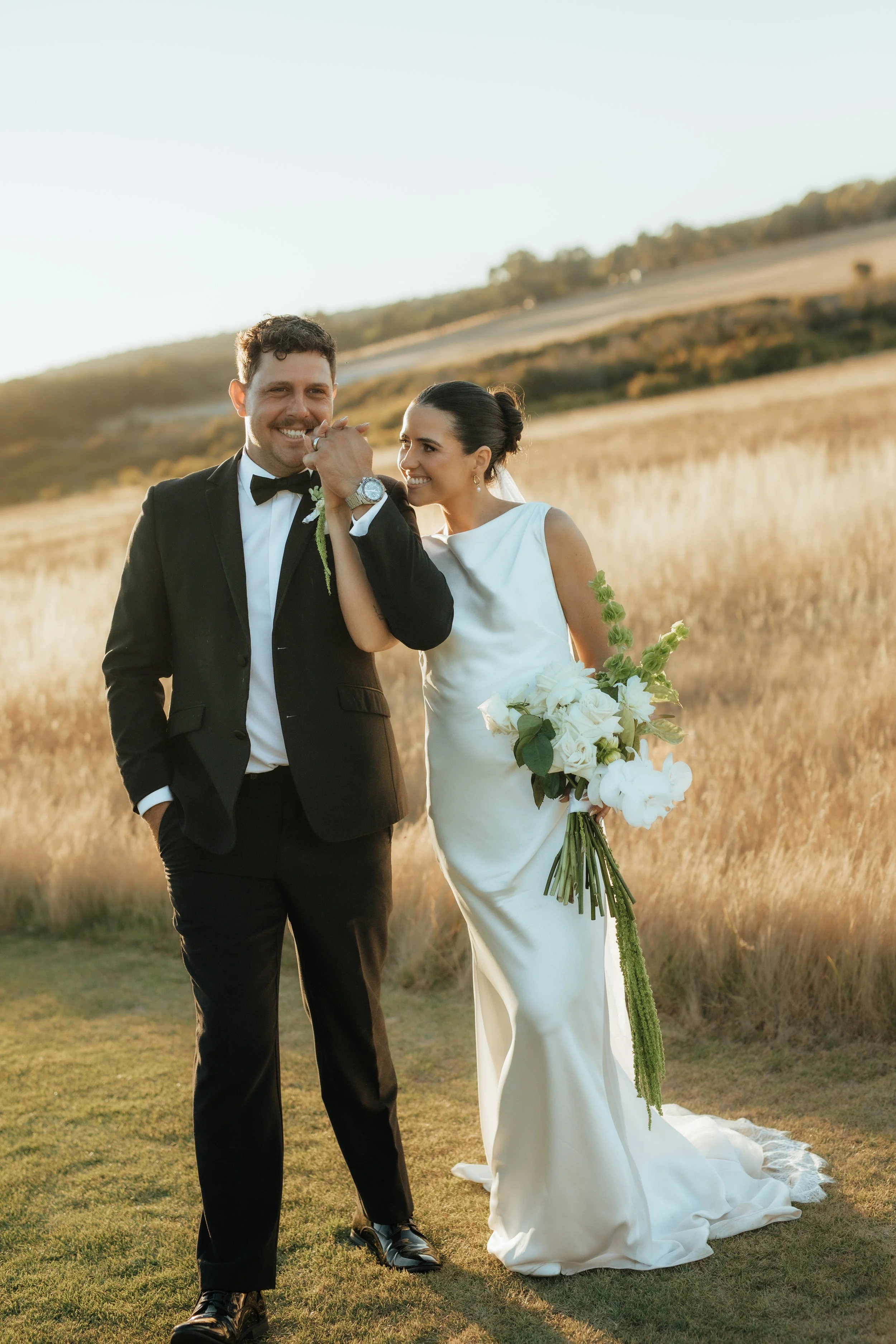 Newlyweds at tiller farm during golden hour in front of the paddock south west western Australia 