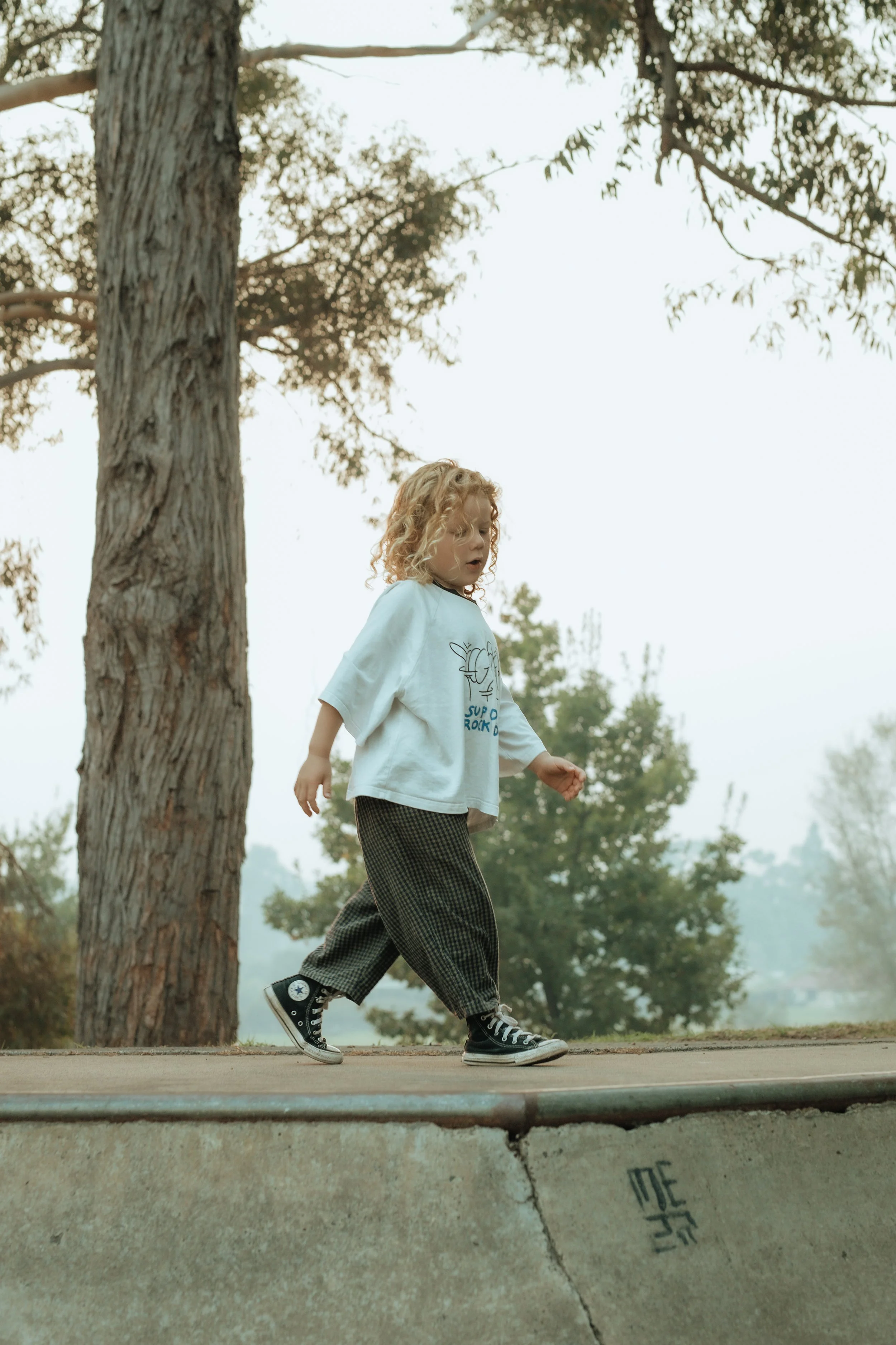 Boy in family photo shoot walking on skate ramp