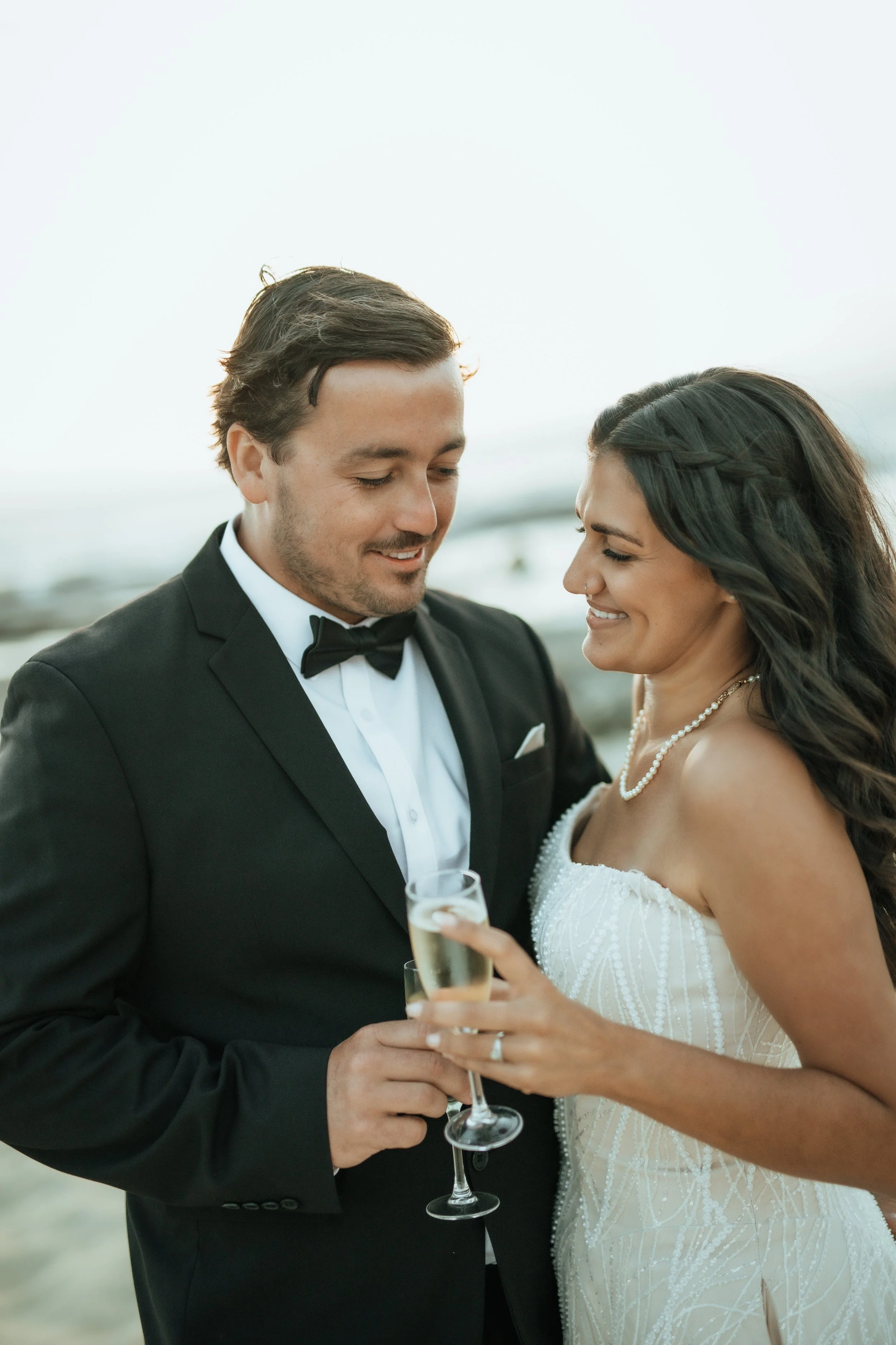 Bride and groom drinking bubbles on the beach in Margaret river