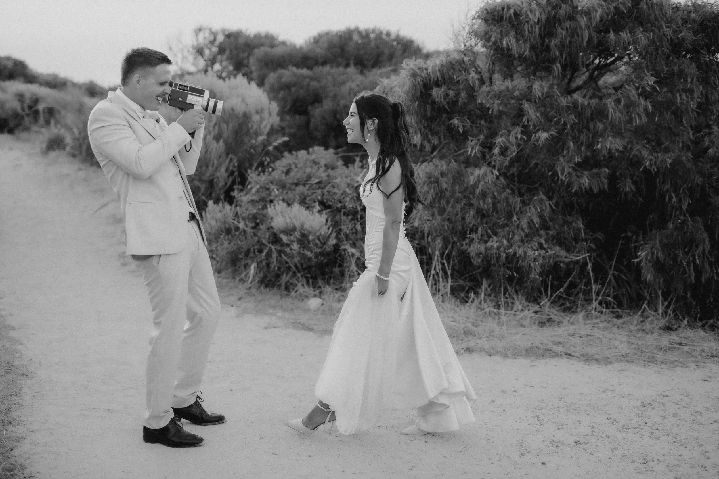 Bride and Groom film each other using super 8 camera at there South west wedding