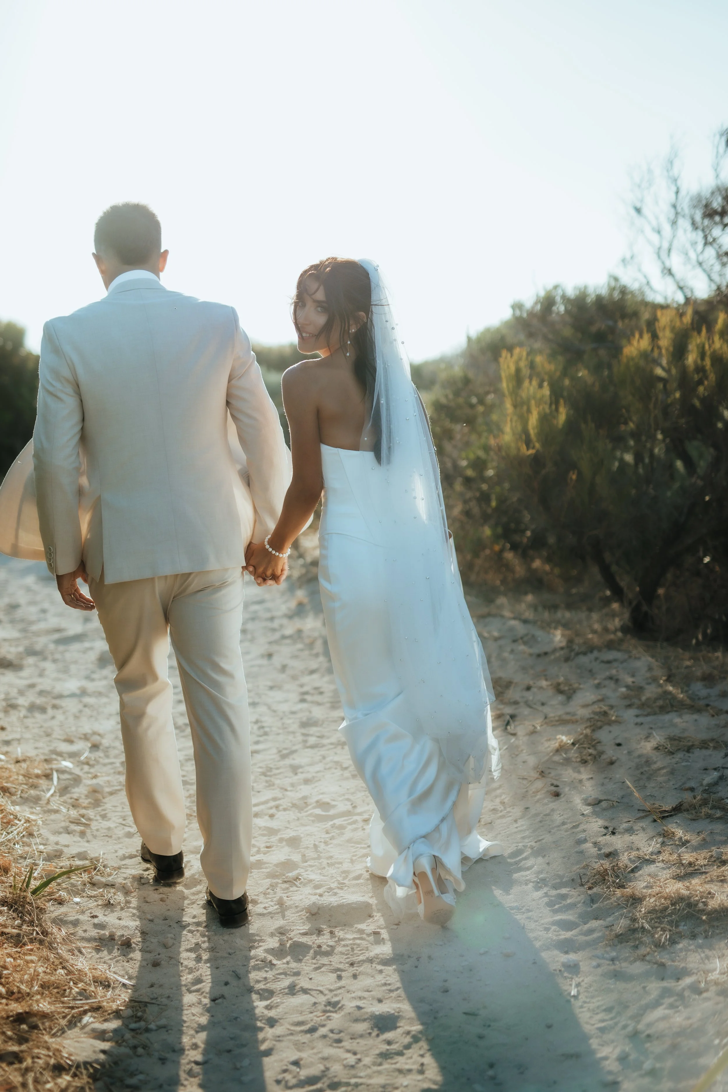 Newlyweds walking in beautiful soft light for their bridal photos in the South west 