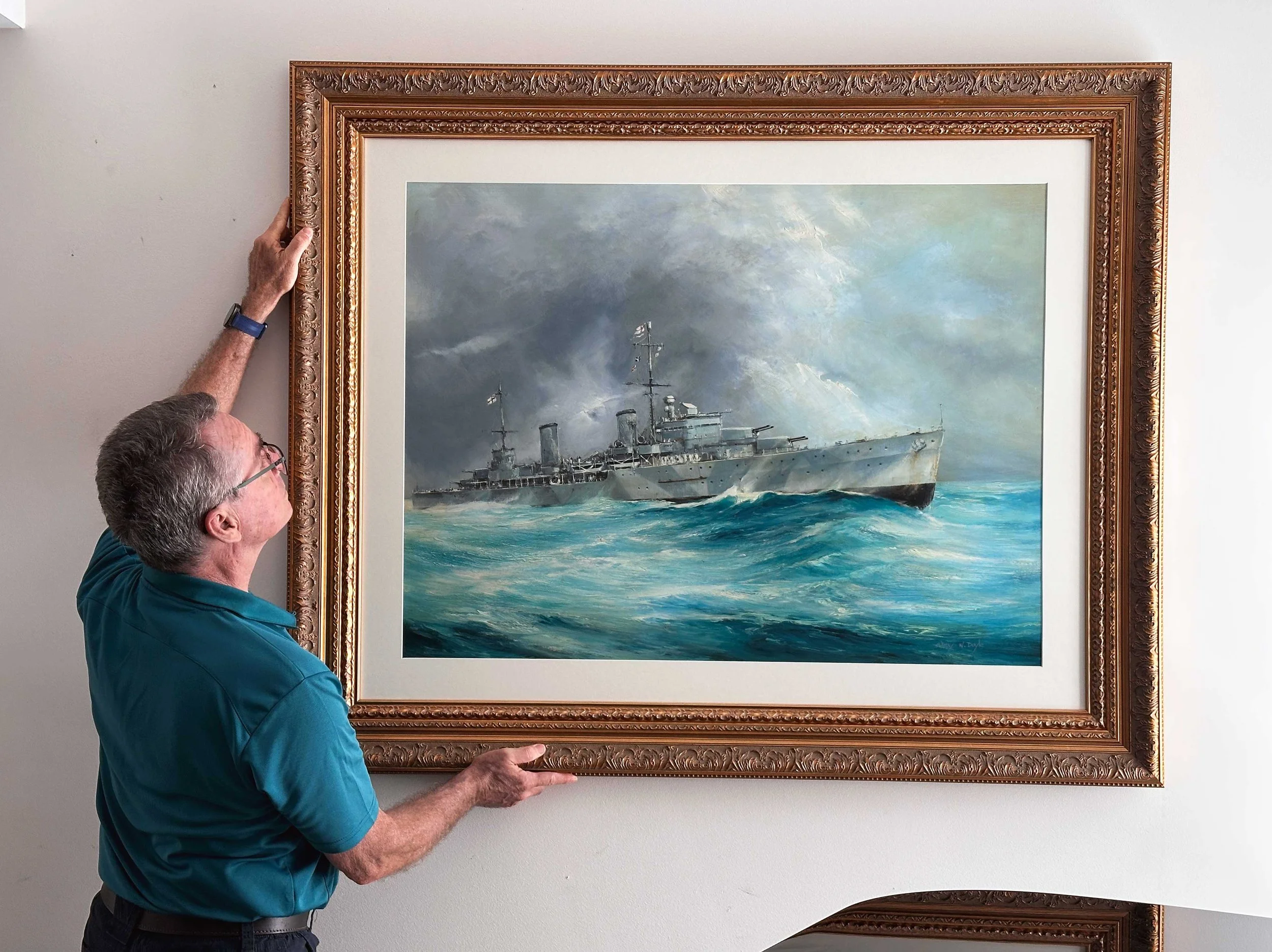 Man hanging a painting