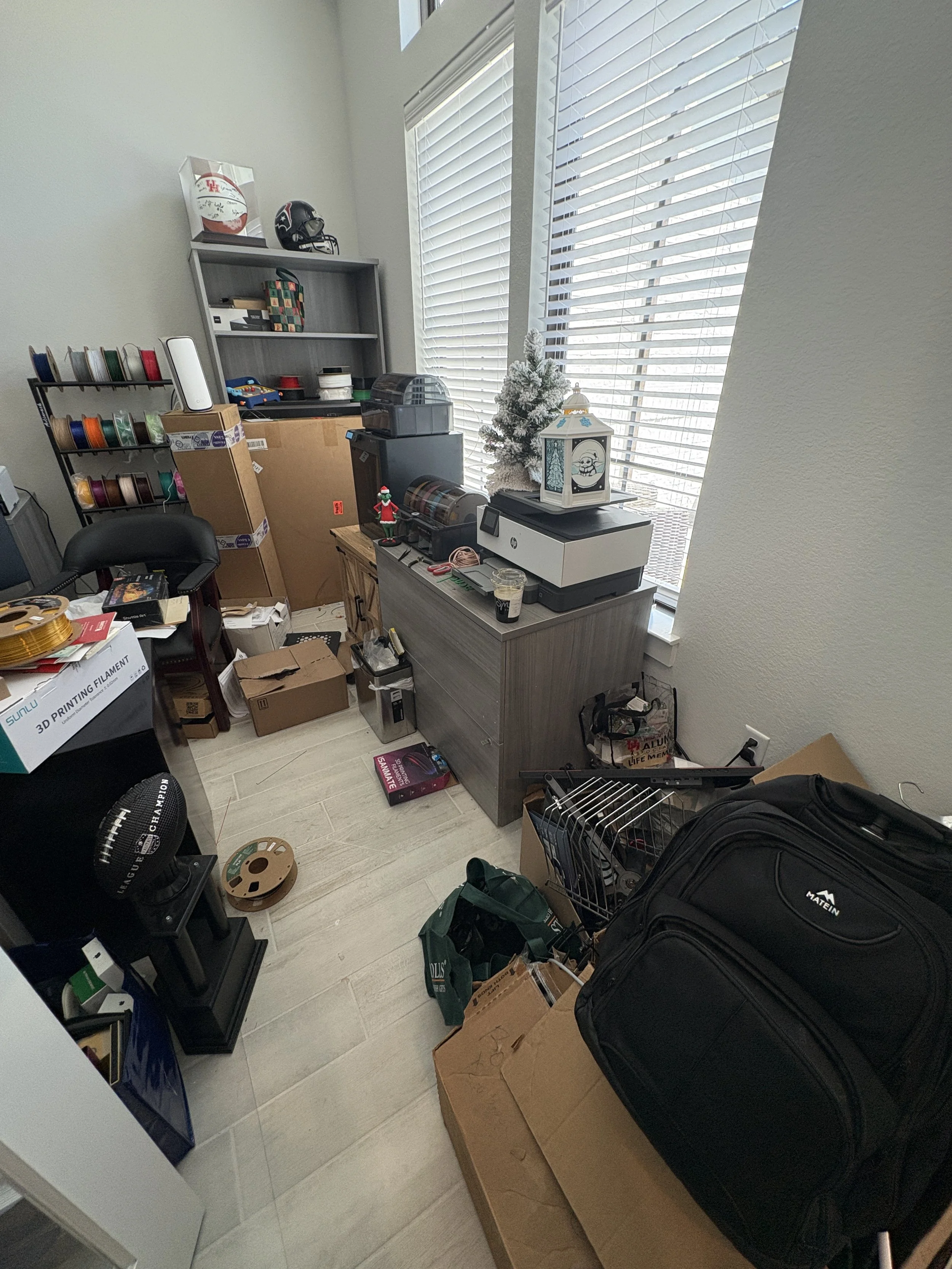 Home office in need of unpacking and decluttering.