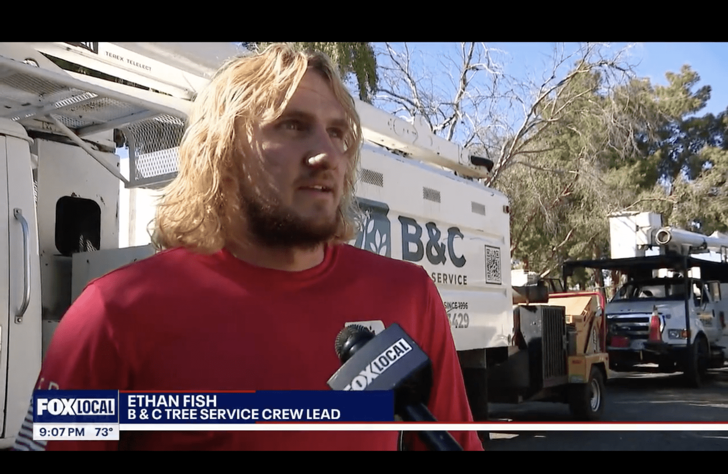 Ethan Fish of B&C Tree Service speaking with FOX 10 beside B&C equipment