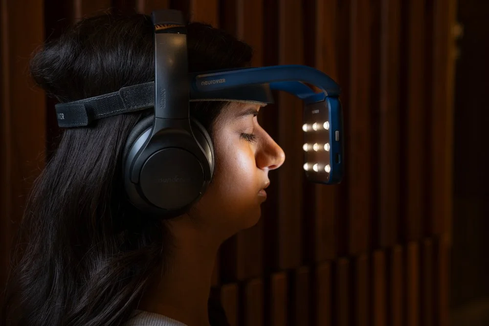 Person wearing a Neurovisor device with headset and LED lights