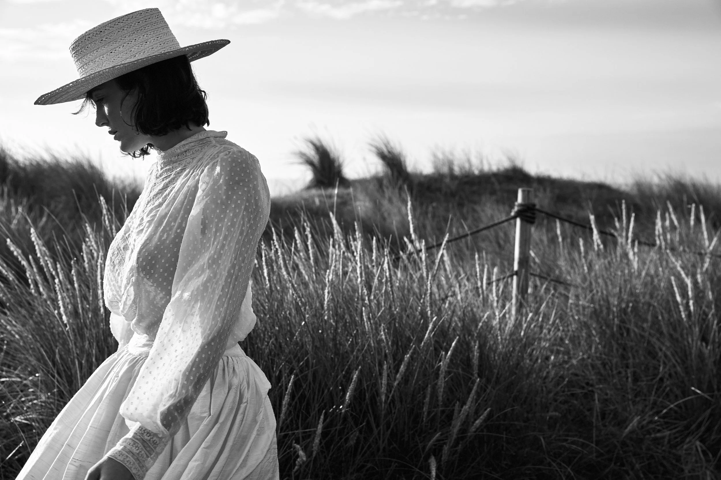 black and white modelwalking past dune grasses.jpg