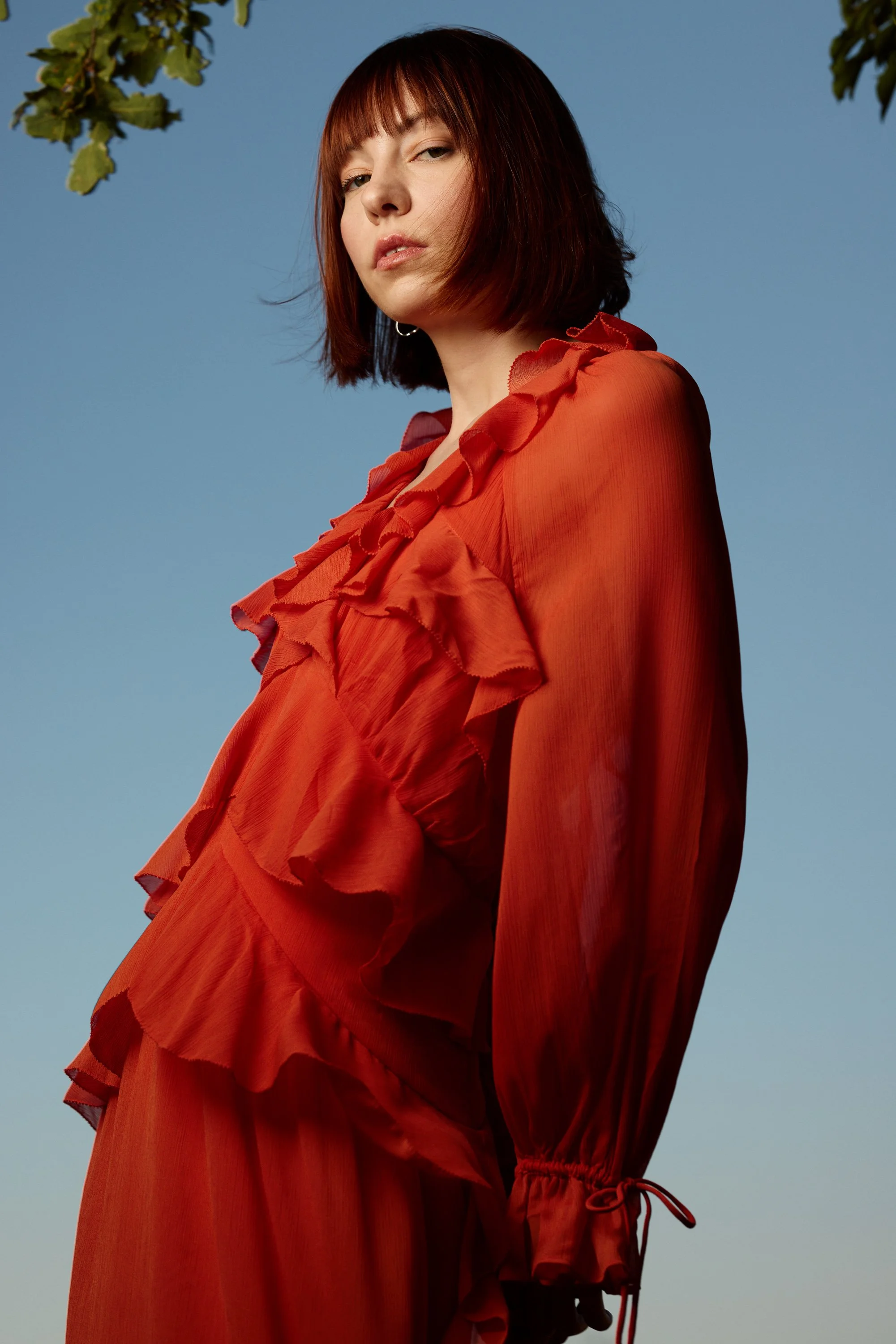 model in a red dress against blue sky.jpg