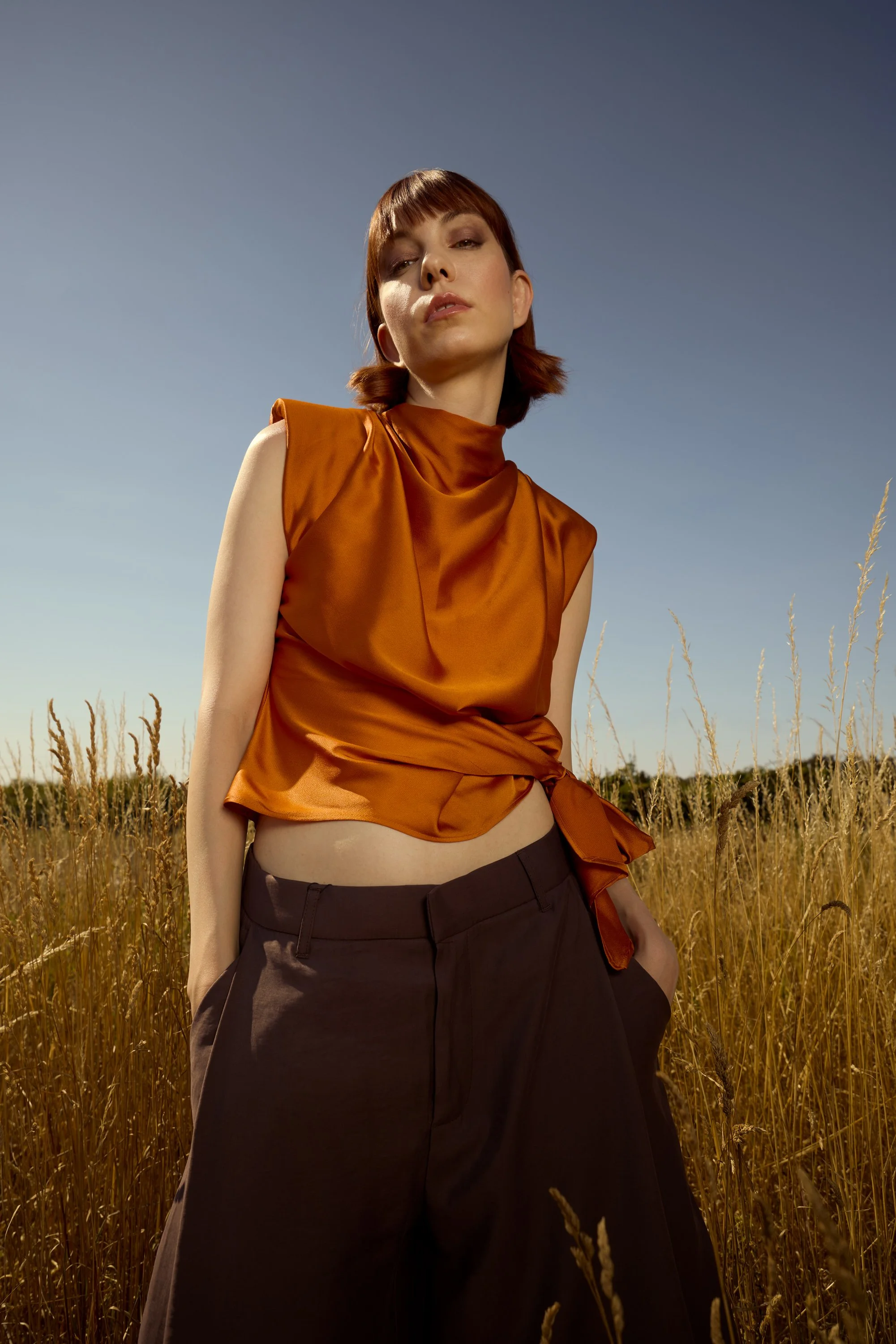 model in a orange top in grass.jpg