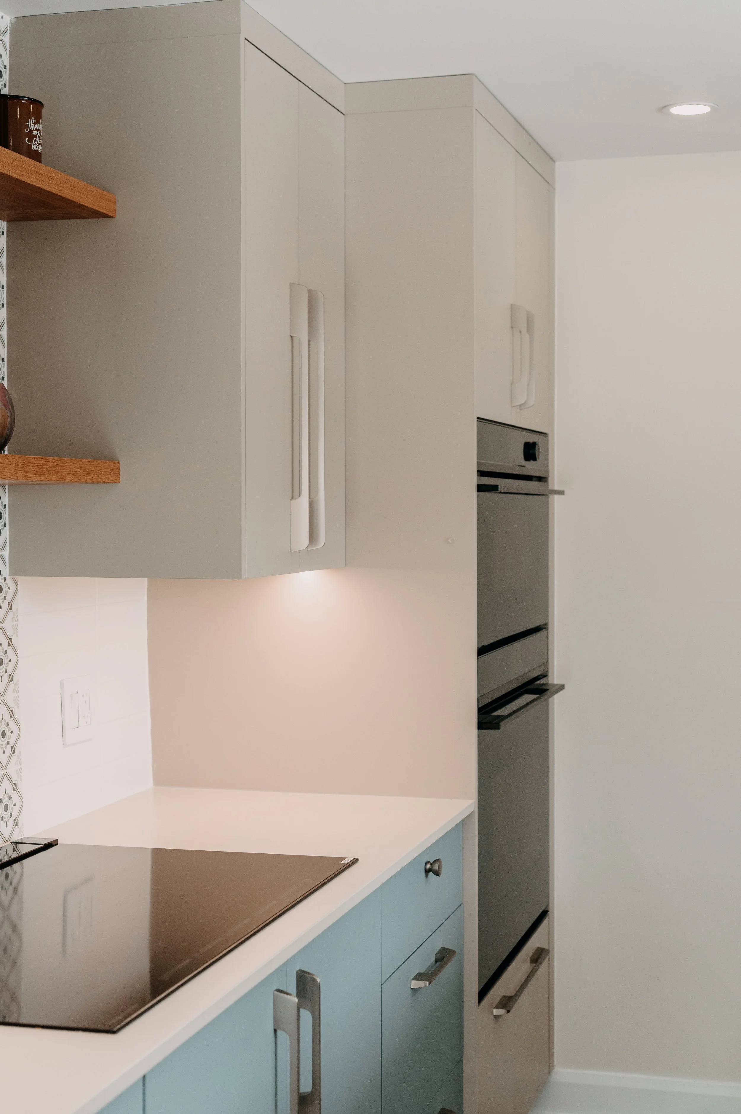 Built-in double wall oven in a blue and greige kitchen, Kirkland home.