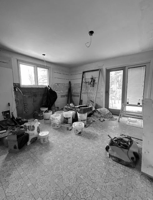 Original kitchen space mid-demolition before this Kirkland renovation, stripped down to studs and subfloor.